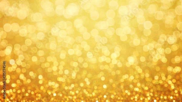Fototapeta Golden glittering background. Sparkle glitter texture with the bokeh and the lights, shiny metal gold foil