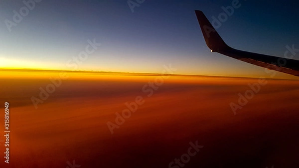Obraz airplane flying above clouds