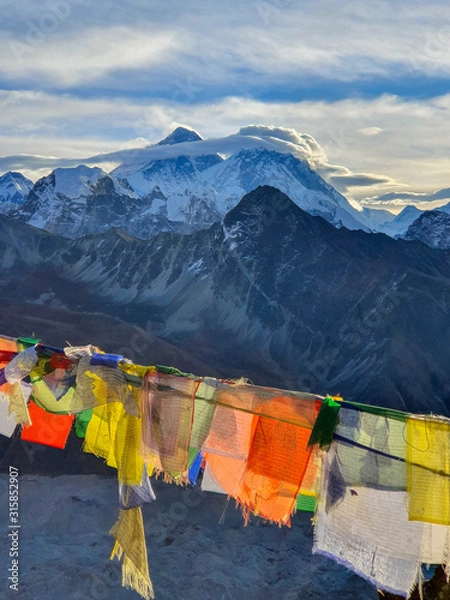 Fototapeta Picturesque view on Everest, Nuptse mountains and buddhist colorful praying flags. At the top of Gokyo Ri at sunrise. Trekking in Solokhumbu, Nepal, Himalayas.