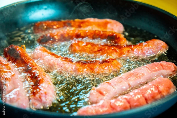 Obraz Frying some sausages