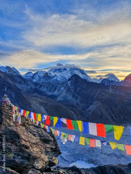 Obraz Picturesque view on Everest, Nuptse, Cholatse mountains and buddhist colorful praying flags. At the top of Gokyo Ri at sunrise. Trekking in Solokhumbu, Nepal, Himalayas.