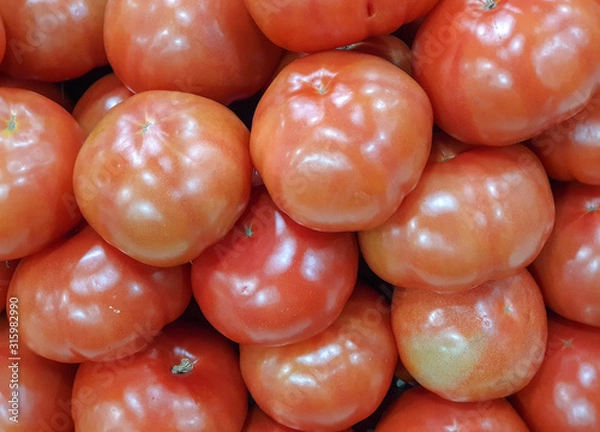Fototapeta Fresh red tomatoes in a supermarket. Tomato texture, background. Copy space.