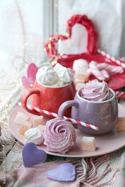 Fototapeta Two cups of coffee with meringues and marshmallows, Turkish delight on a plate, hearts, illumination, against the background of a window, homeliness, Valentine's day, romantic greeting, happy birthday