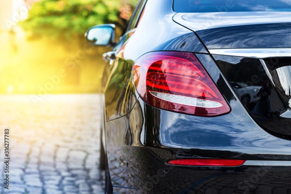 Obraz Mercedes E-Class - luxury black car from behind - view on taillight