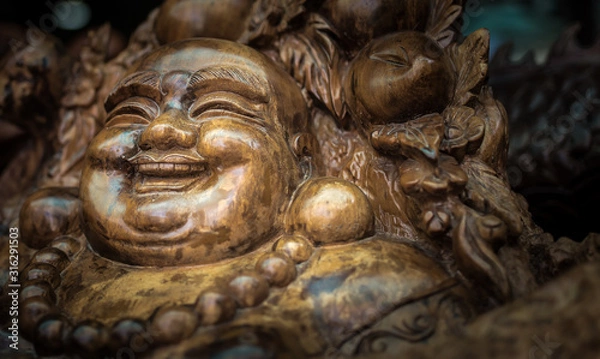 Obraz Smiling Buddha. Decorative woodwork made for the armchair.
