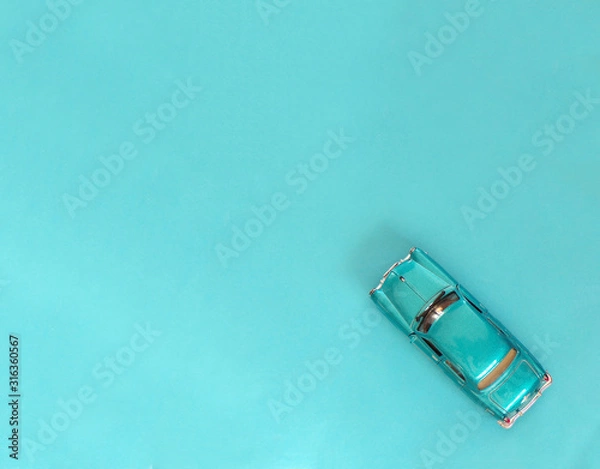Fototapeta Blue car on a blue background with space copying. Car in retro style.