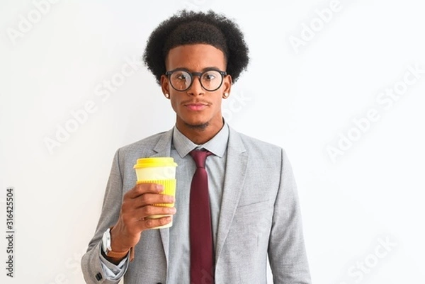Fototapeta African american businessman drinking cup of coffee over isolated white background with a confident expression on smart face thinking serious