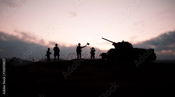 Fototapeta War Concept. Military silhouettes fighting scene on war fog sky background, World War German Tanks Silhouettes Below Cloudy Skyline At night. Attack scene.