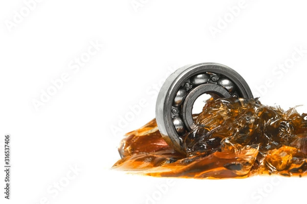 Obraz Closed up macro, ball bearing put into yellow transparent lithium grease isolated on white background with copy space, engineering and industrial concept