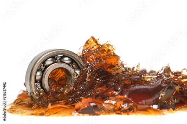 Obraz Closed up macro, ball bearing put into yellow transparent lithium grease isolated on white background with copy space, engineering and industrial concept