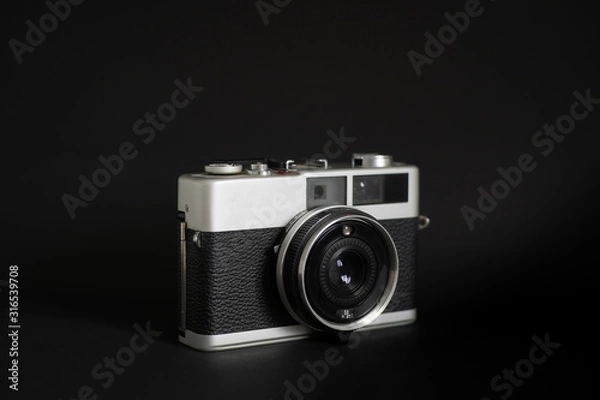 Obraz Vintage camera in black background 