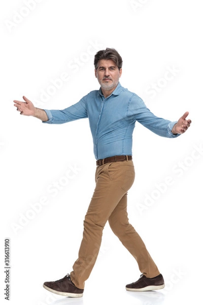 Fototapeta Side view of a positive casual man greeting