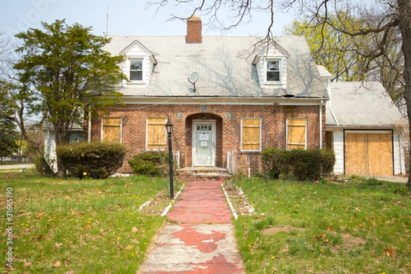 Fototapeta Boarded Up Home in Foreclosure