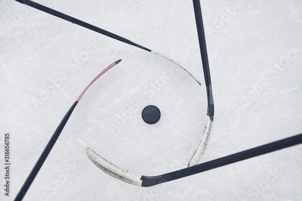 Fototapeta Above view background of hockey clubs circling pluck ready to start match on skating rink, copy space