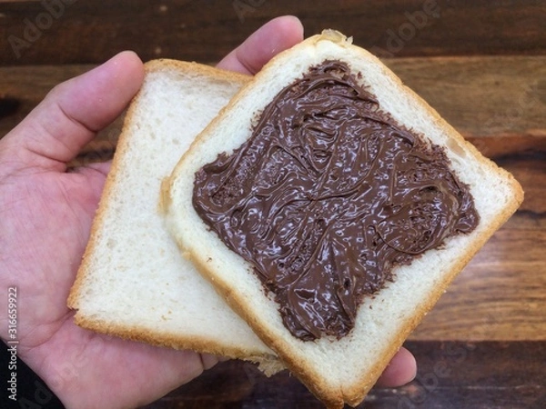 Obraz Bread covered with nutella, can be eaten at every meal