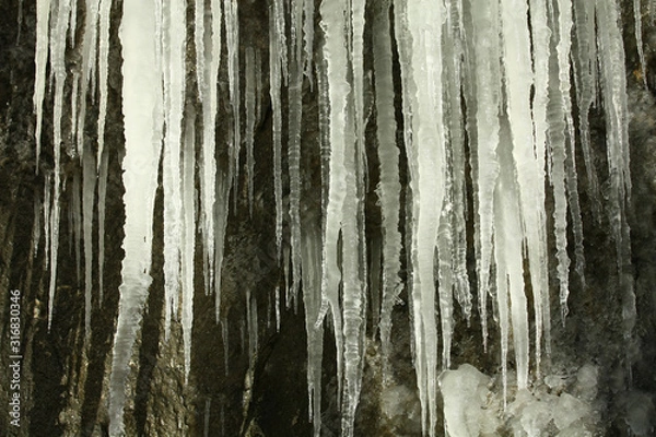 Fototapeta Icicles on a rock