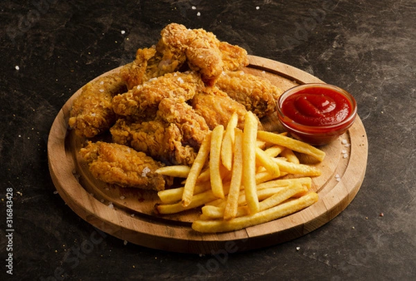 Obraz Fried chicken wings, french fries and ketchup sauce