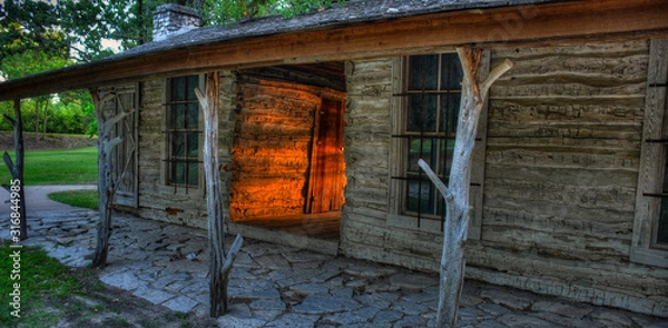Obraz Log Cabin with Sunlight at Sunset