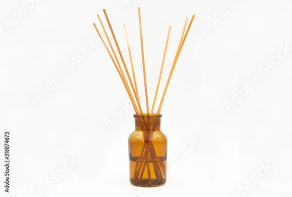Fototapeta reed diffuser incense sticks in glass bottle isolated on white background