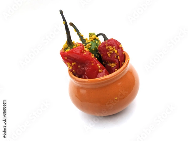 Fototapeta fresh green and red chilli pickle put in a bowl isolated on white background
