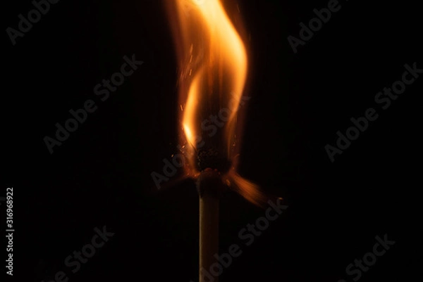 Fototapeta Ignition of match with sparks isolated on black background space for text fire concept passion figures variety