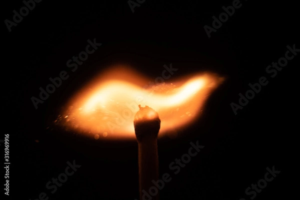 Fototapeta Ignition of match with sparks isolated on black background space for text fire concept passion figures variety