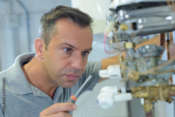 Fototapeta technician is checking air conditioner