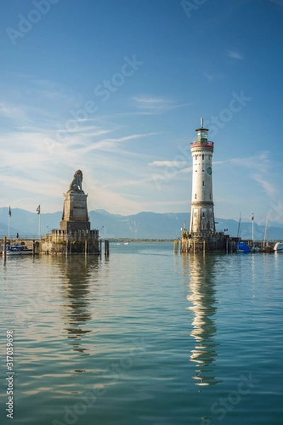 Fototapeta Harbour entrance of Lindau, Lake Constance - Germ. - Bodensee - with the new lighthouse and the Bavarian Lion. The Lindau lighthouse is the southernmost lighthouse in Germany