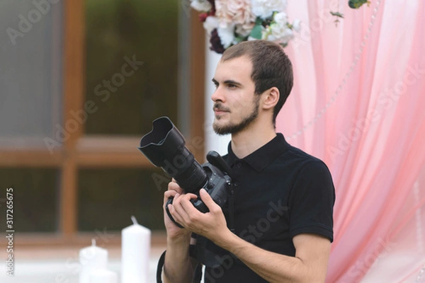 Fototapeta young man with camera at yard