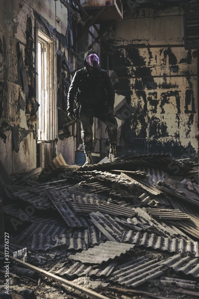 Fototapeta solitary wanderer surveys abandoned building in post apocalyptic wasteland