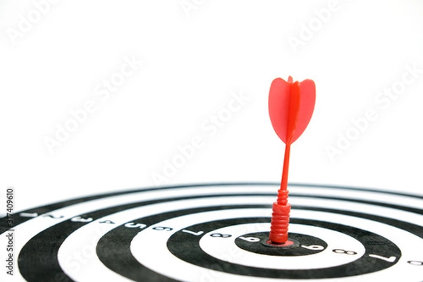 Fototapeta Wooden dartboard with red arrow on white background