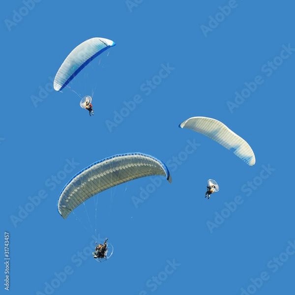 Obraz White blue paramotor on blue sky