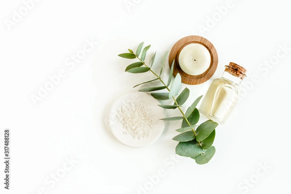 Fototapeta Bottle of eucalyptus essential oil, eucalyptus leaves on white background. Natural / Organic cosmetics products. Flat lay, top view.