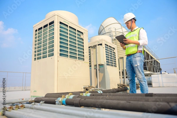 Fototapeta Engineer check condition cooling tower project at industry by tablets, measuring equipment for filling air conditioners.