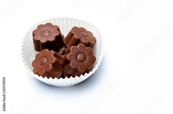 Obraz Daisy shaped chocholate assortments in a paper basket
