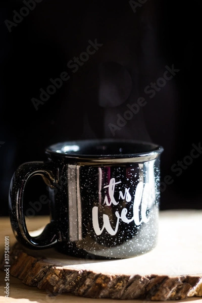 Fototapeta Black mug with it is well phrase and steam