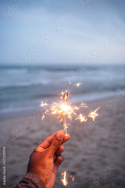 Fototapeta Celebrating with a sparkler