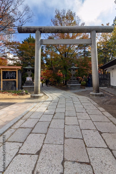 Fototapeta Yohashira Shrine (meaning four pillars) in Autumn, a landmark in Matsumoto city, Japan. Was built during the Meiji Period and is dedicated to four Shinto deities.