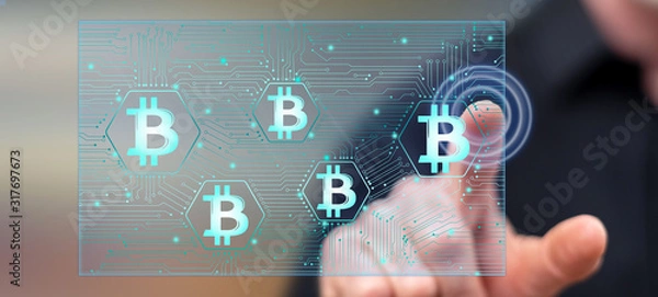 Fototapeta Man touching a bitcoin concept