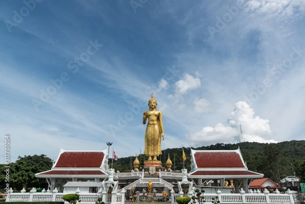 Fototapeta Translation on buddha image's feet text "Phra Buddha Mongkol Maharaj" is located on the hill at Hat Yai Municipality Park, Hat Yai district, Songkhla, Thailand.