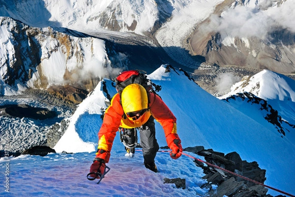 Obraz Climber ascending the summit of mountain peak. Climbing and mountaineering sport concept, Nepal Himalayas