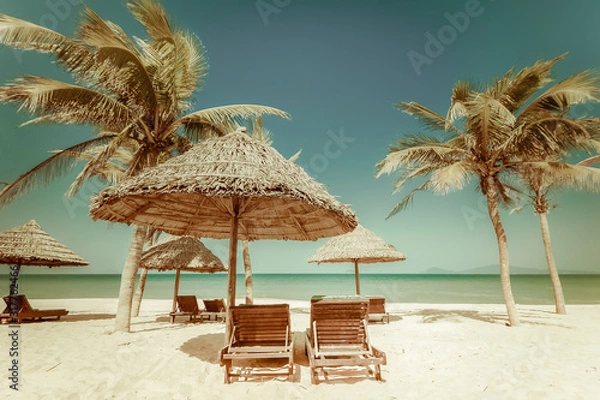 Obraz Amazing tropical beach with palm trees, chairs and umbrella on sand. Travel nature landscape in vintage style. Vietnam