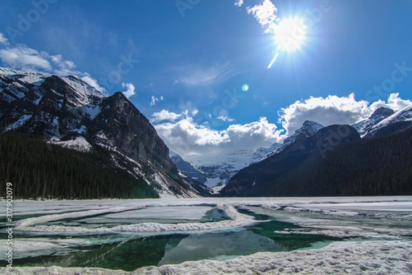 Obraz Lake Louise in a beautiful sunny day Mountain wild lake in Rocky Mountains in early spring still frozen with snowy mountains 