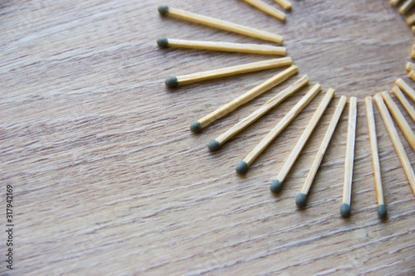 Obraz circle lined with matches are on a beige wooden