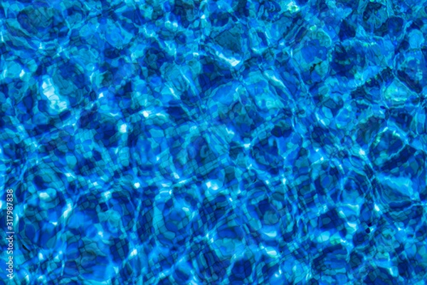Fototapeta Blue background with lots of light spots. Sun glare in the pool