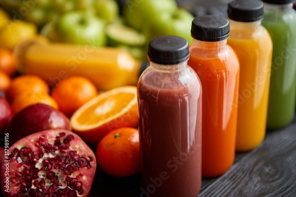 Fototapeta Colorful bottles filled with fresh fruit and vegetable juice or smoothie
