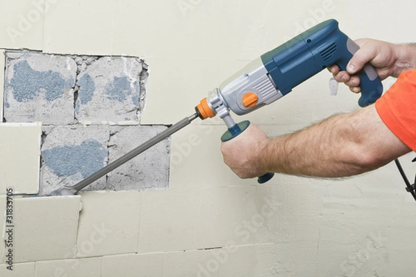 Obraz House-builder working with a perforator