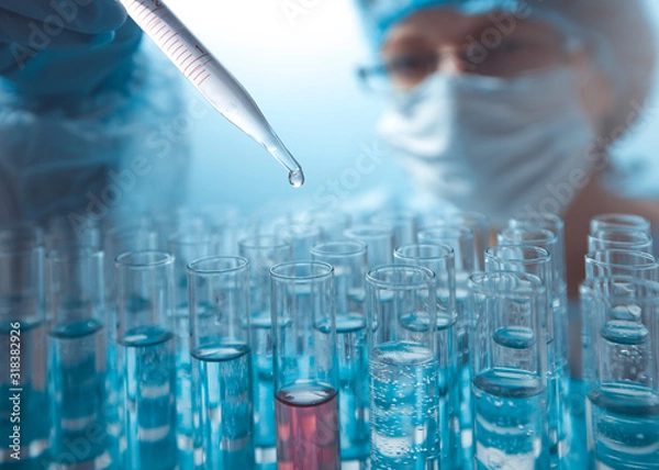 Obraz A drop is dripping from a pipette into a test tube. Laboratory research. 