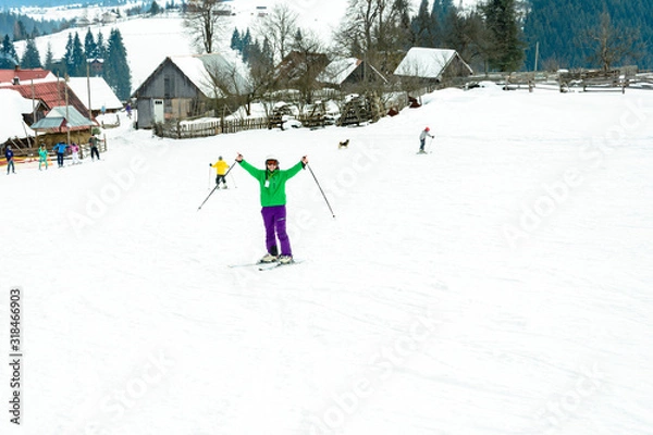 Obraz A man is skiing in the Carpathian village.