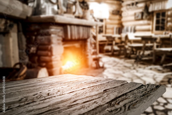 Fototapeta Desk of free space and blurred background of home interior with fireplace 